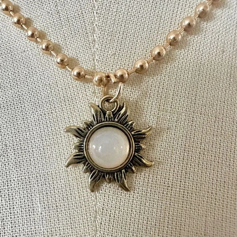 Gold tone sun pendant necklace